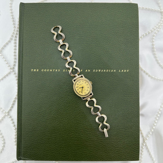 Collectable vintage gold tone Custom Time Antimagnetic manual winding watch with unique chain link band and round dial.