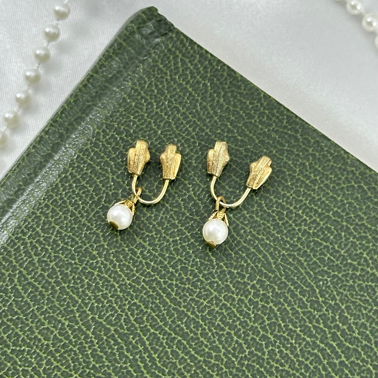 Vintage dainty gold tone wire pinch close style clip on earrings with faux pearls.