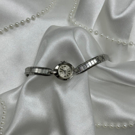 Dainty silver tone Benrus 17 Jewels manual winding watch