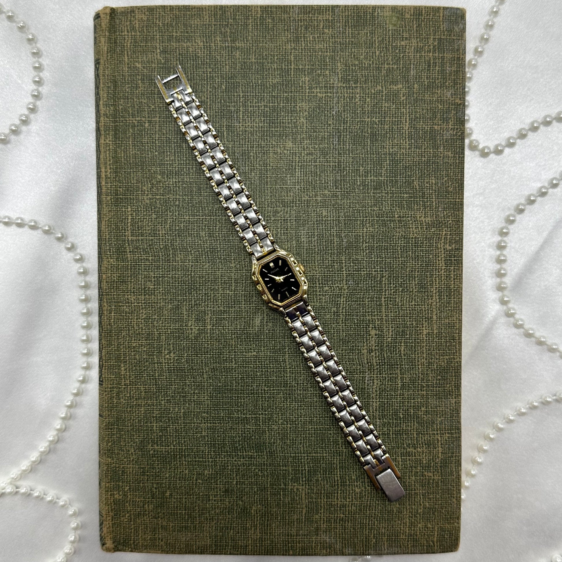 Dainty vintage silver and gold tone Pulsar watch with quartz movement.