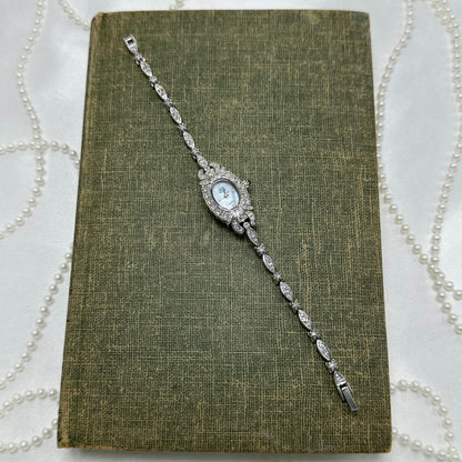 Elegant Crystal Silver Nolan Miller Watch with Mother of Pearl Dial