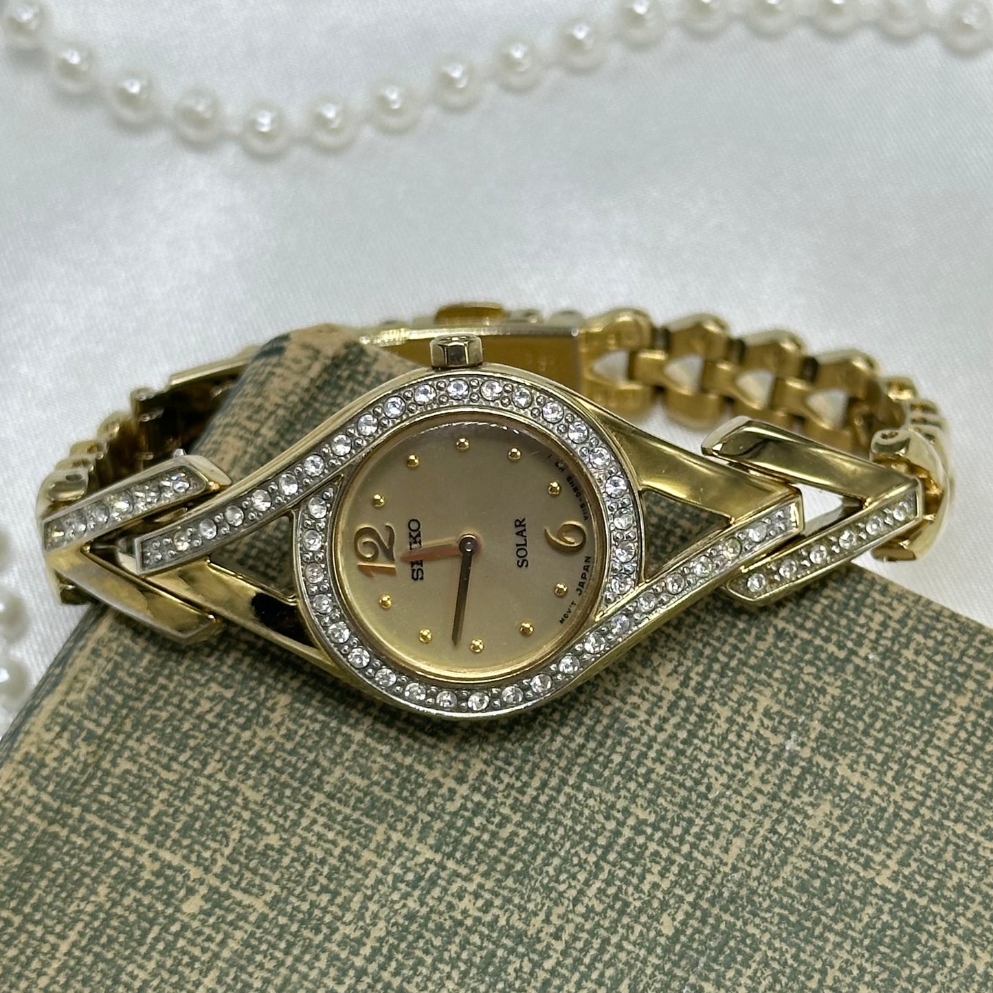 Elegant vintage gold tone Solar Seiko watch featuring sparkling Swarovski crystal accents