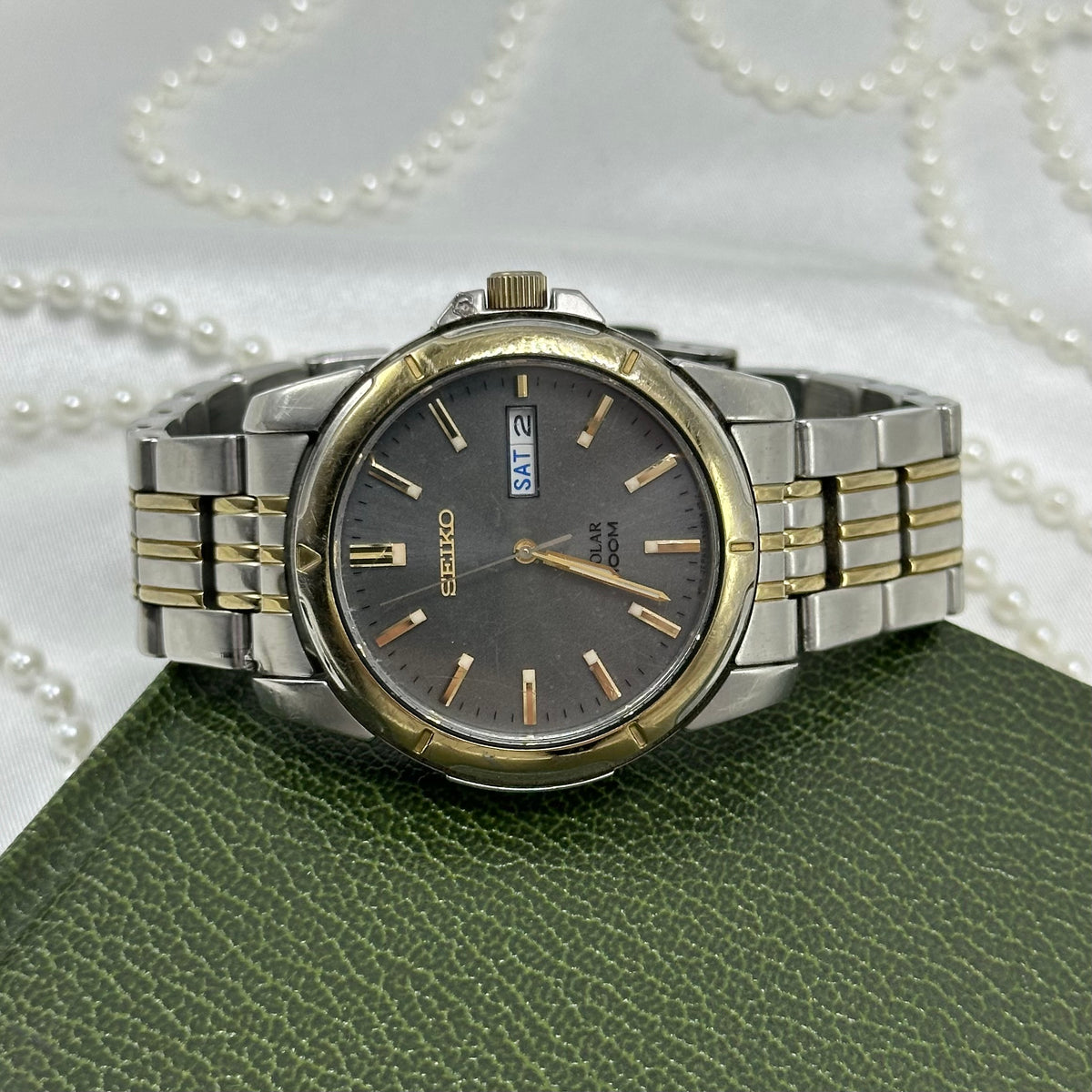 Seiko men's SNE098 solar gold and silver tone tank watch with date display.