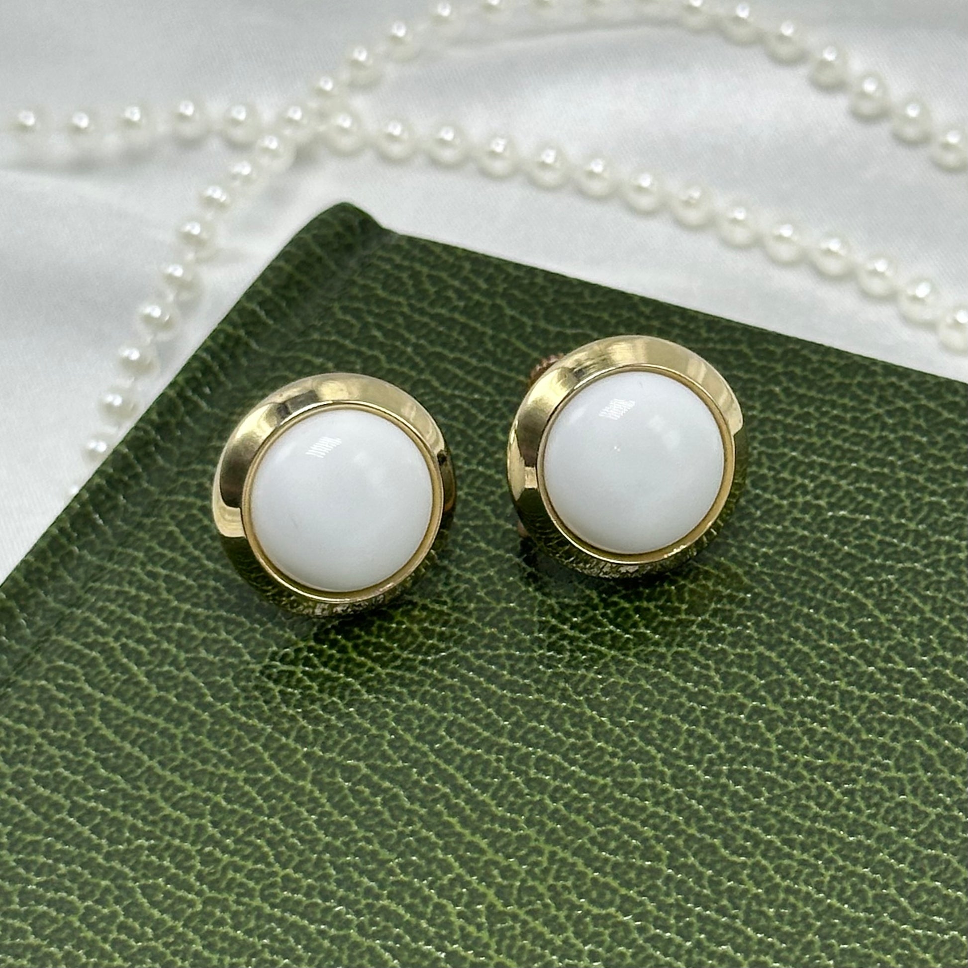 Vintage white button style gold tone clip on screw back earrings.