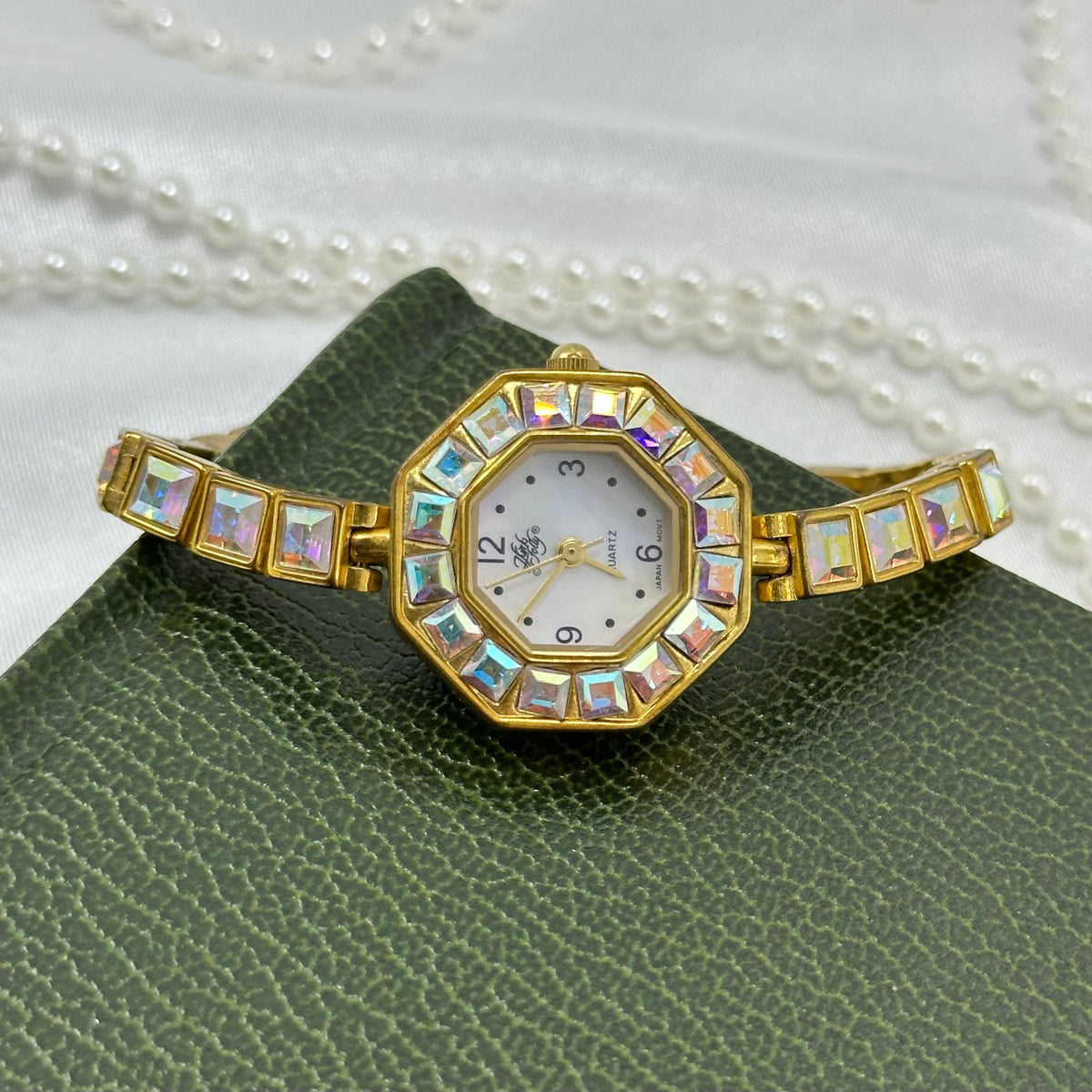 Vintage rare gold tone Kirks Folly watch covered in aurora borealis stones with octagon dial.