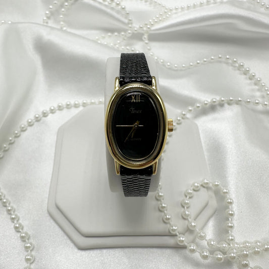 Gold and Black Timex Oval Dial Watch