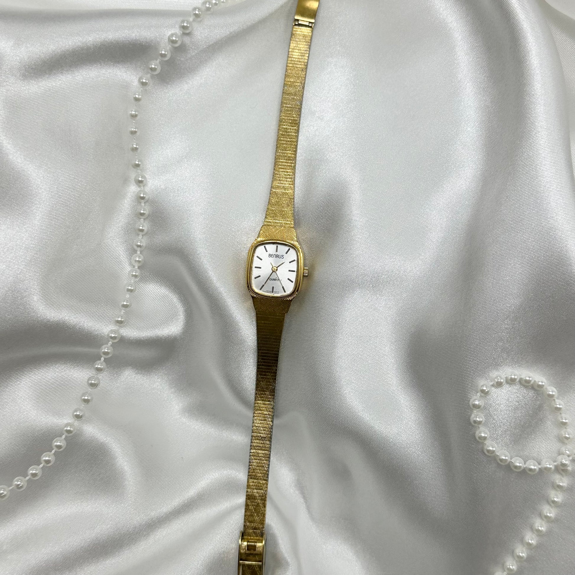 Gold tone Benrus watch with square dial