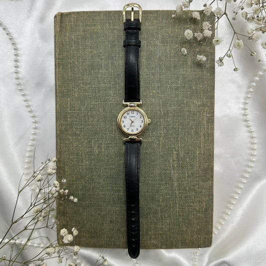 Gold tone Carriage watch with genuine leather black band and quartz movement.
