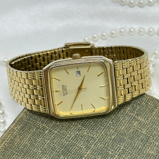 Gold tone Citizen square dial watch with date display and quartz movement.