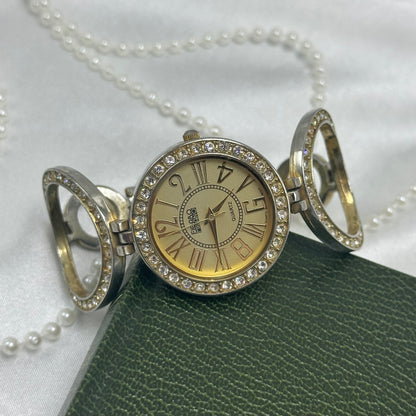 Gold tone Figaro Milano watch with large round diamanté dial and circle links.