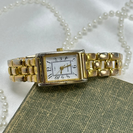 Gold tone Timex watch with rectangle dial and quartz movement.