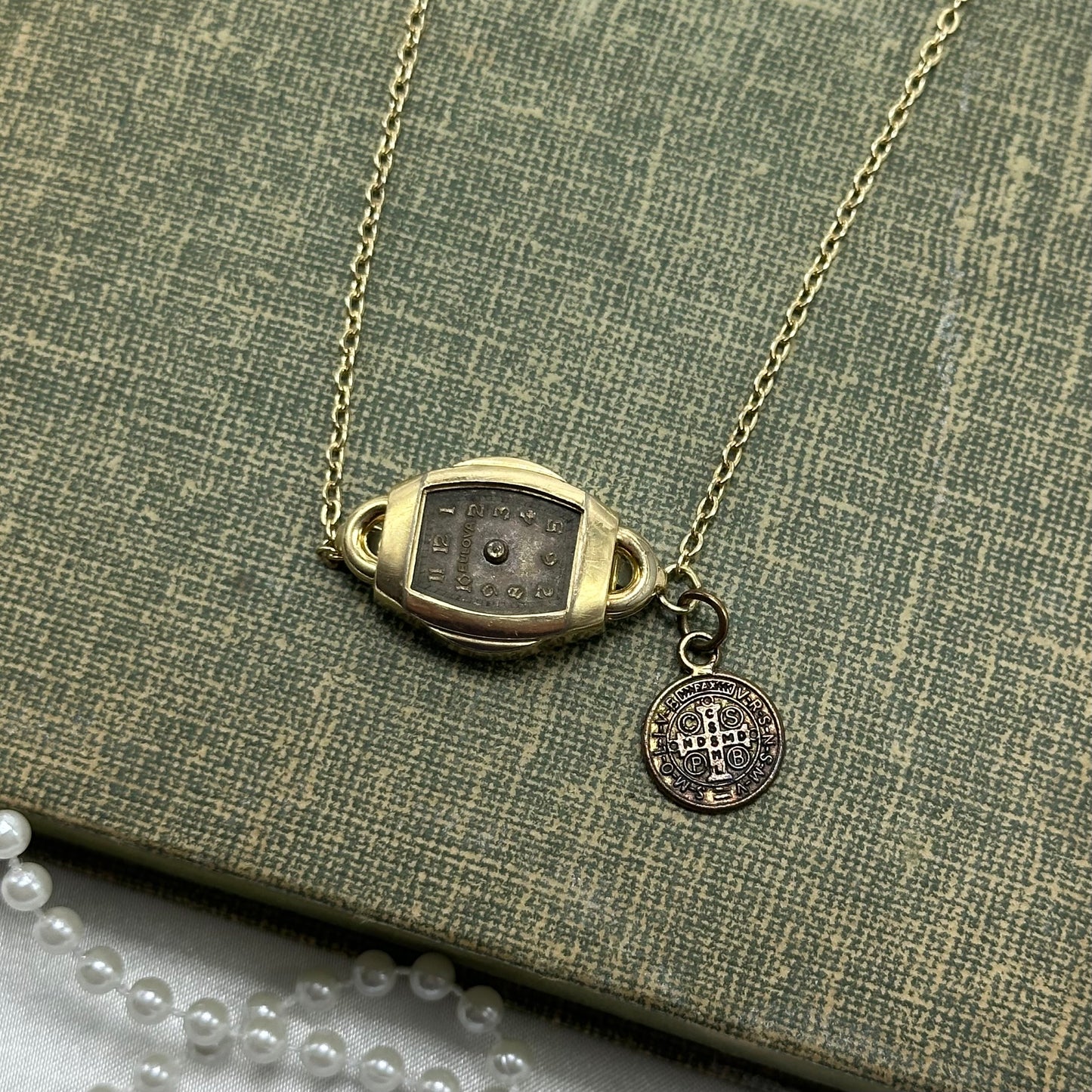Gold tone choker necklace with vintage watch and Saint Benedict 