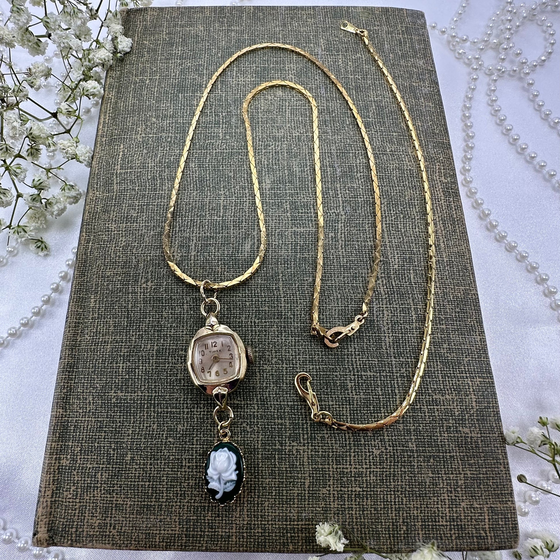 Gold tone necklace with vintage Timex watch and green rose cameo pendant on a cobra link chain. Watch does not run. 
