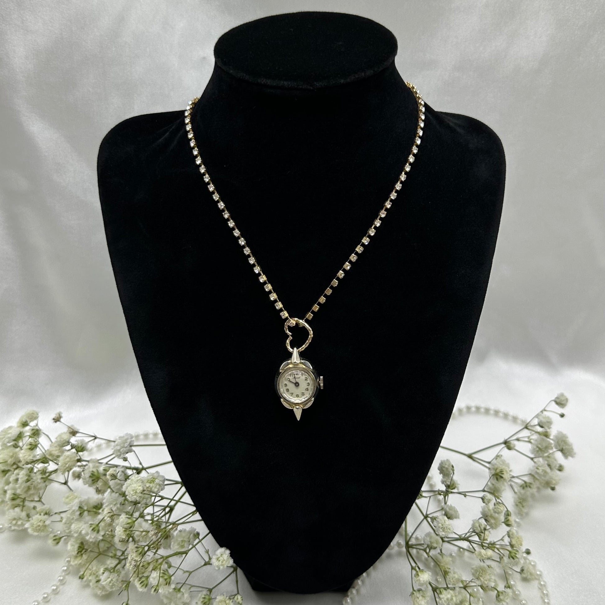 Gold tone rhinestone necklace with heart bail and vintage watch pendant. Watch does not run.