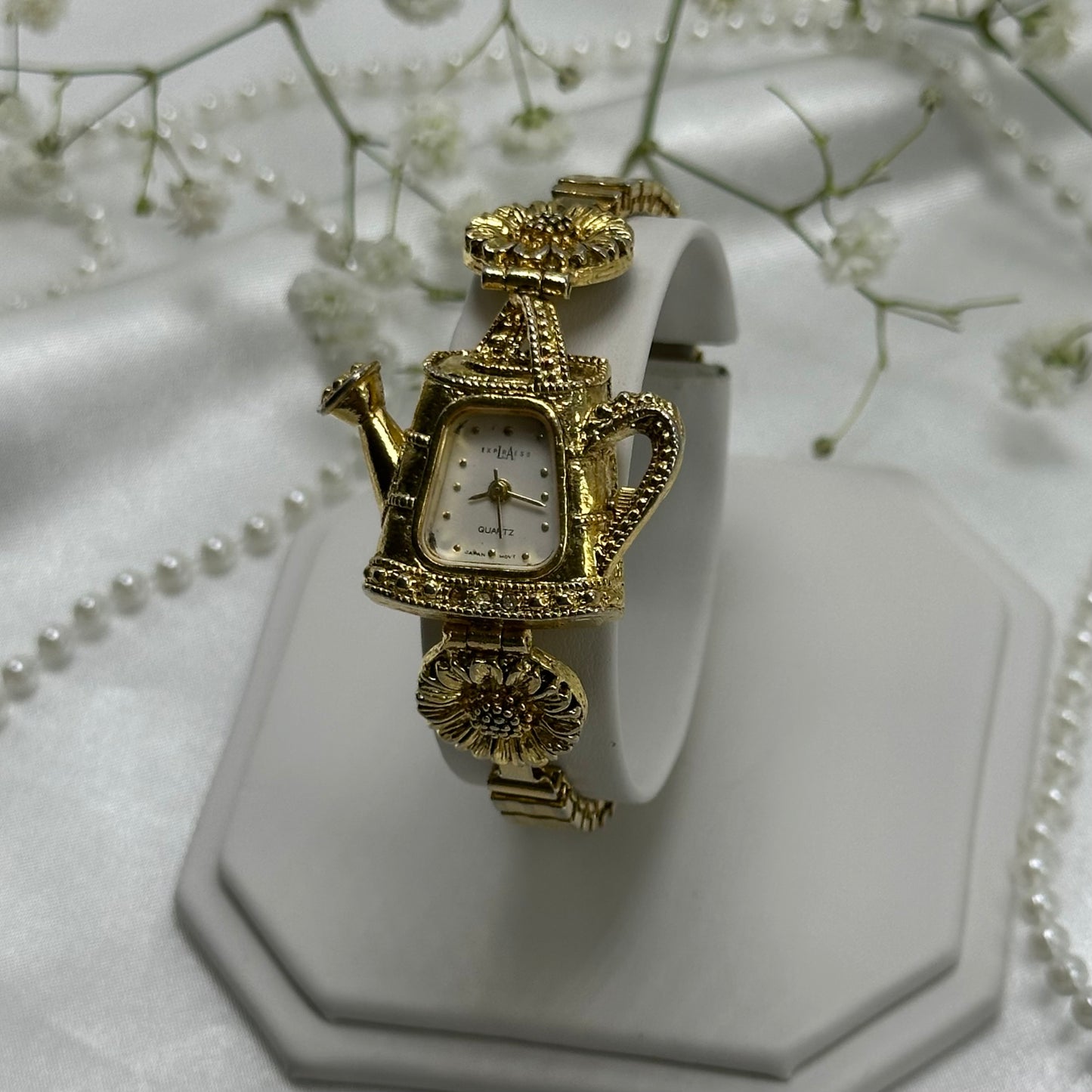 Gold tone sunflowers and watering can LA Express watch