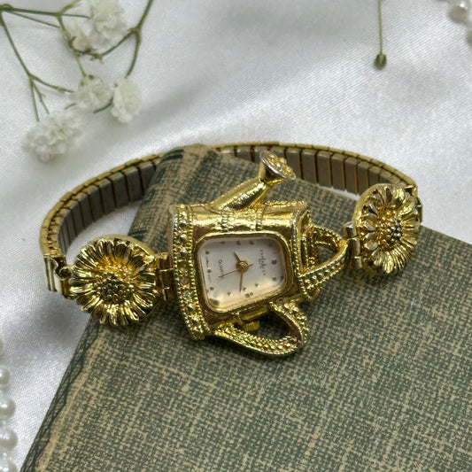 Gold tone sunflowers and watering can LA Express watch with quartz movement