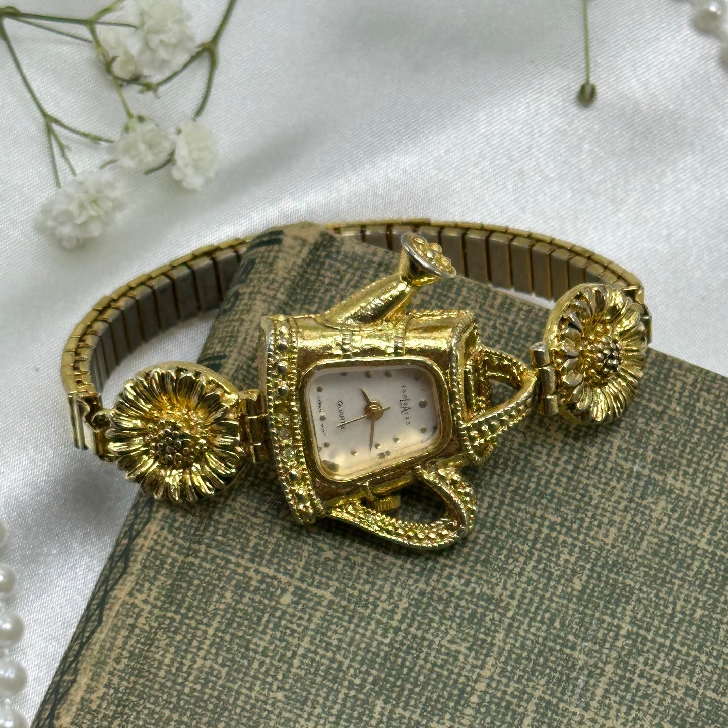 Gold tone sunflowers and watering can LA Express watch with quartz movement