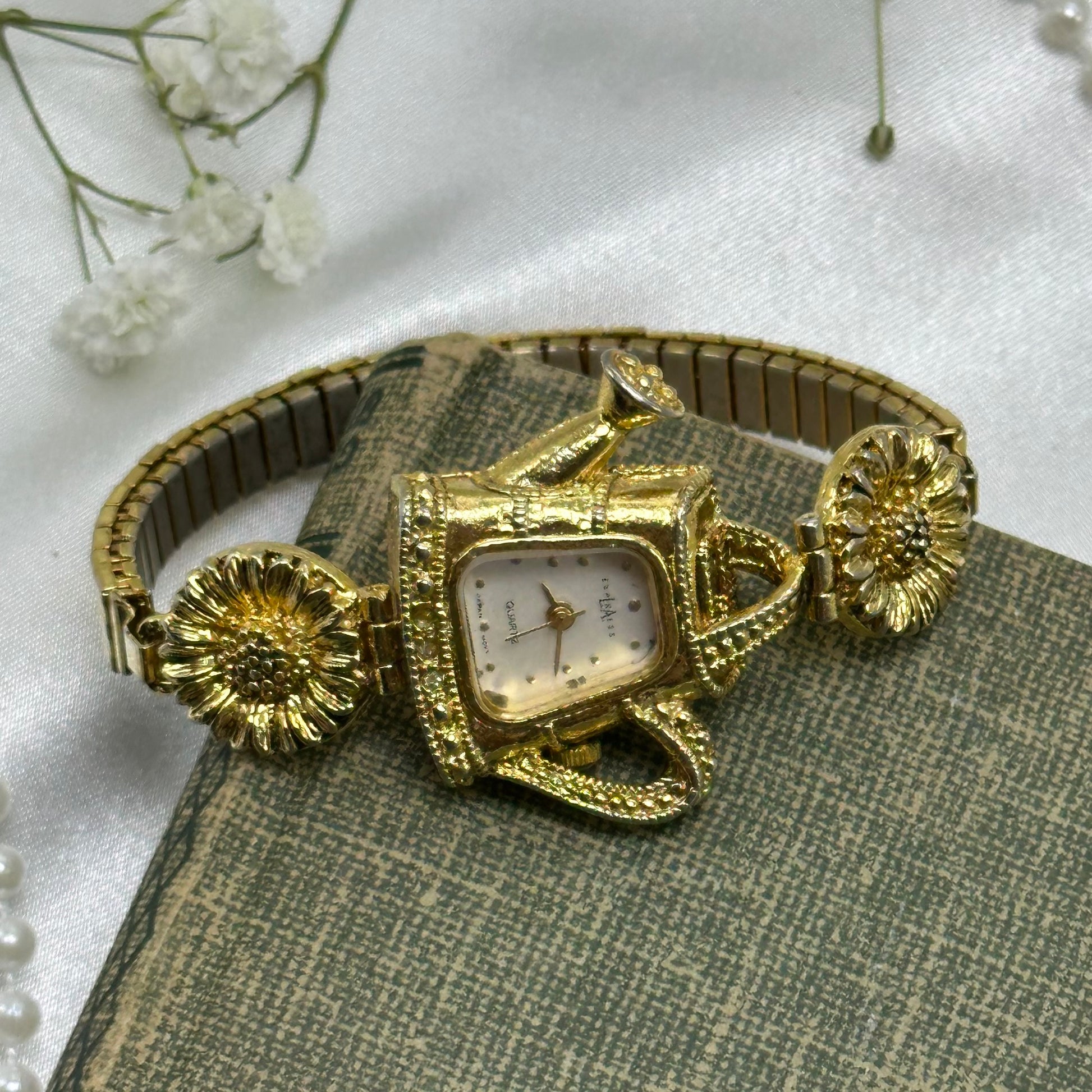 Gold tone sunflowers and watering can LA Express watch with quartz movement