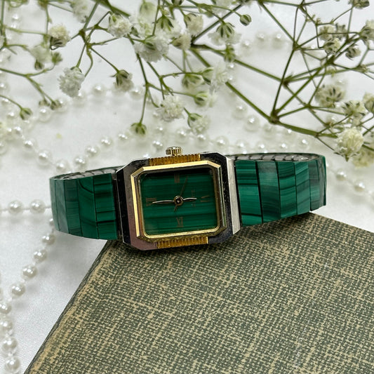 Green and gold tone malachite watch with green dial and stretchable band. Band is missing one panel on the bottom.