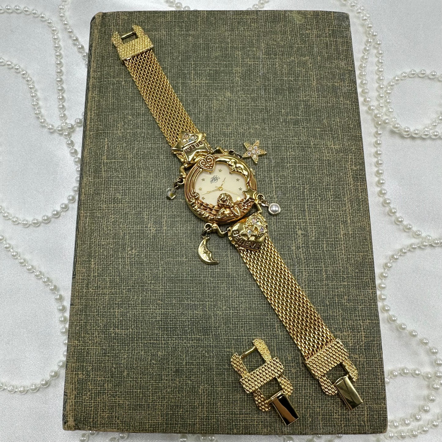 Rare vintage gold tone Kirk's Folly "Angel Time" watch with moon and star charms. Comes with original box and paperwork.