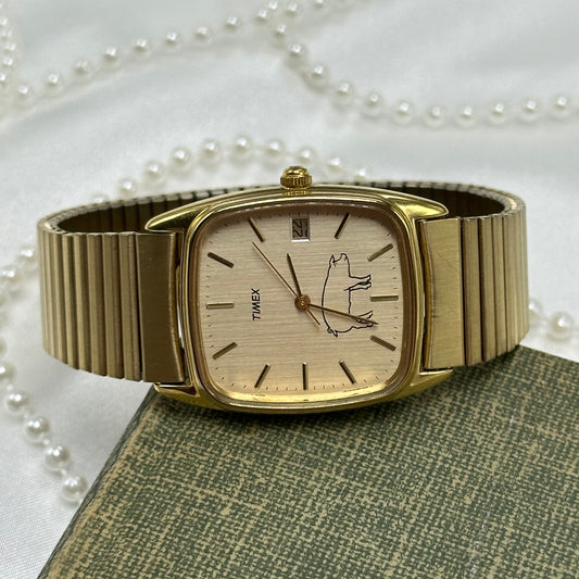 Rare vintage gold tone custom Timex with a pig on the dial. Watch has date display and quartz movement.