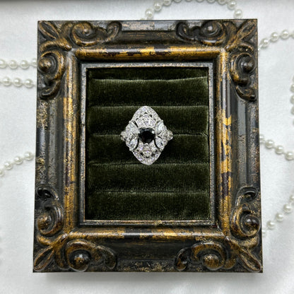 Rhodium plated vintage art deco style silver tone ring with black heart shaped center stone and cubic zirconia stones.