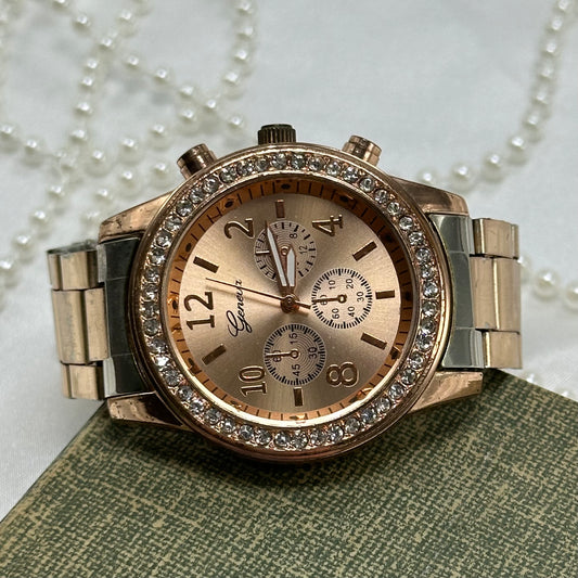 Rose gold tone diamanté chronograph watch with quartz movement.