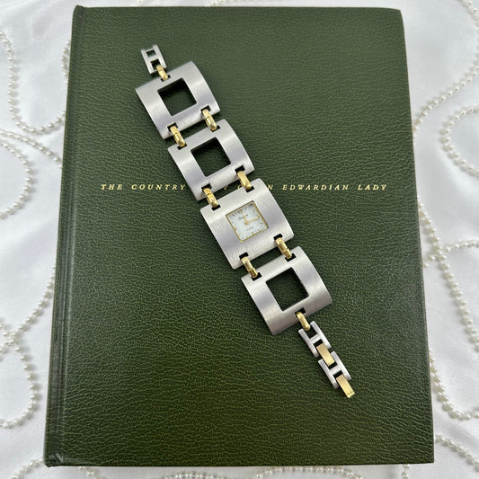Silver and gold tone Geneva Platinum watch with unique square dial and linked square band