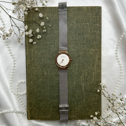 Silver and rose gold tone Skagen Denmark watch with clasp band.