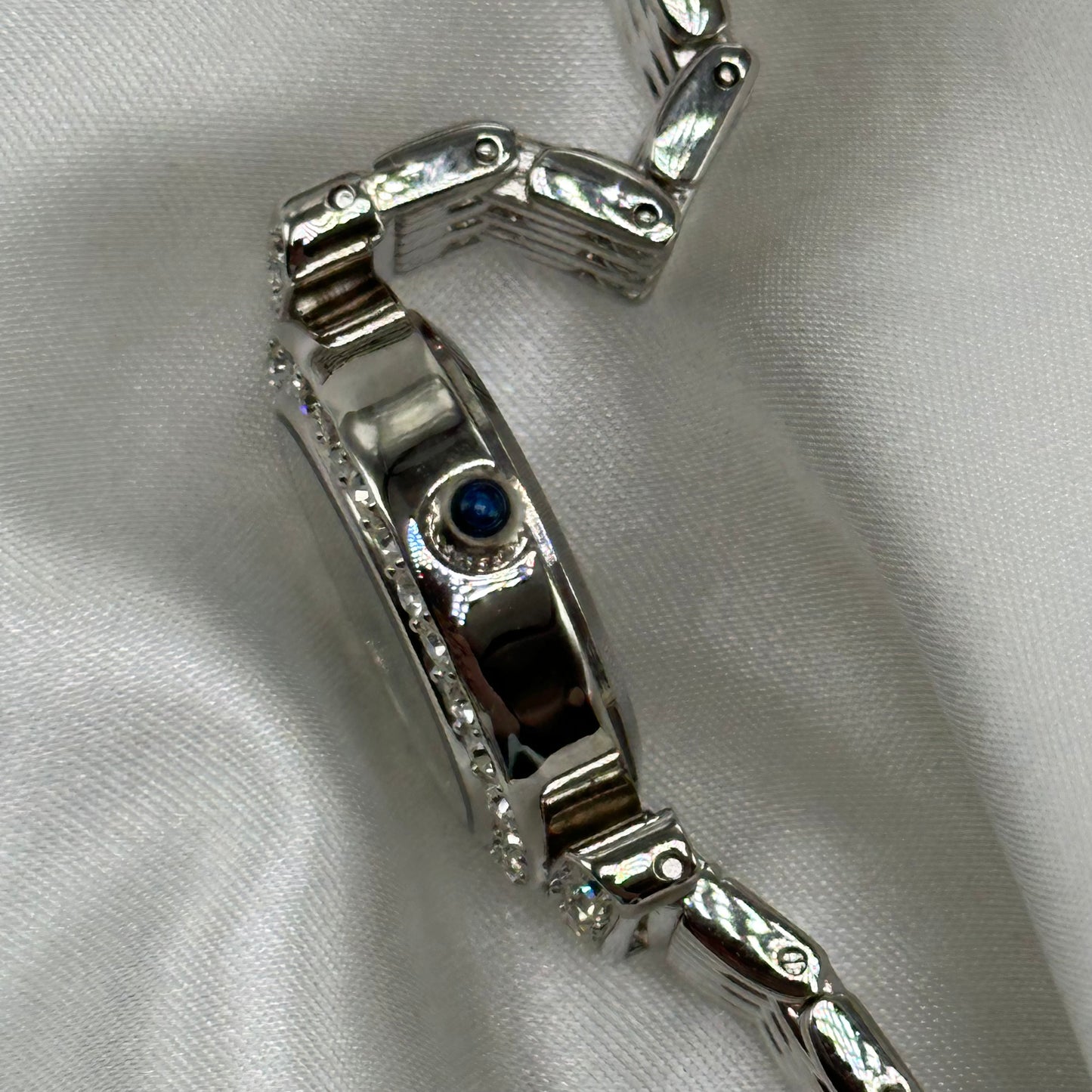 Silver diamanté oval dial watch with quartz movement and mother of pearl dial.&nbsp; Crown is a blue jewel