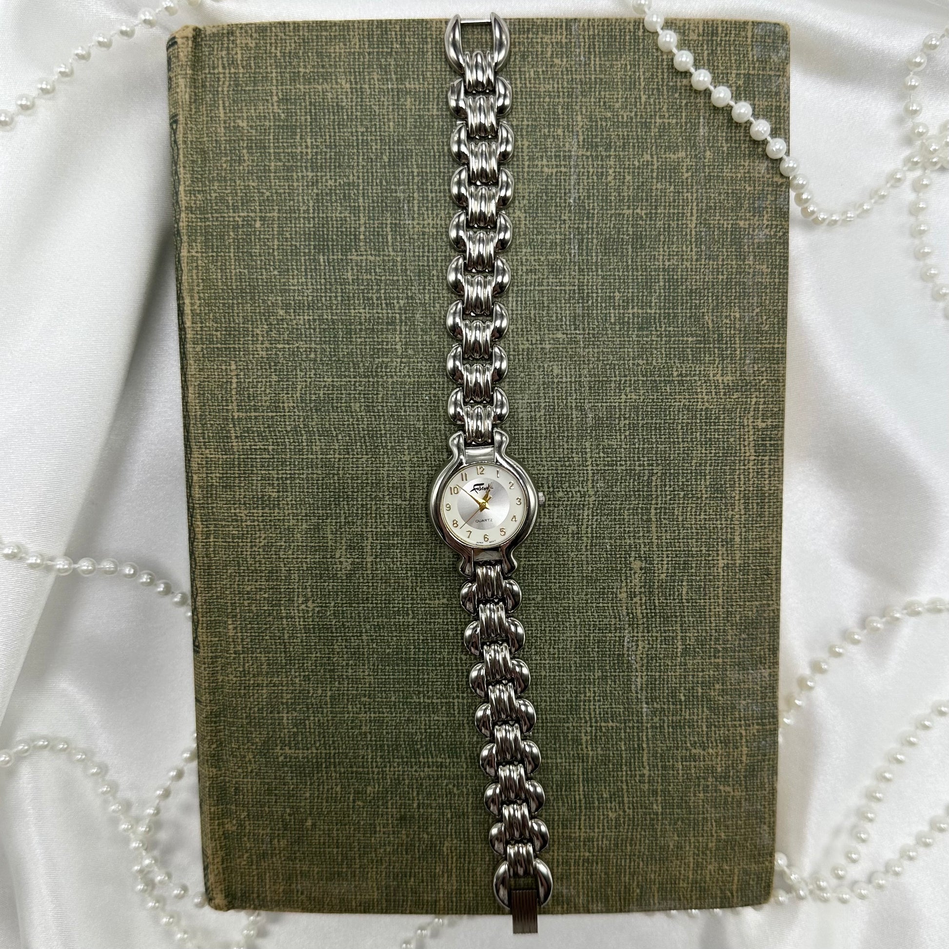Silver tone Fabergé round dial watch with quartz movement
