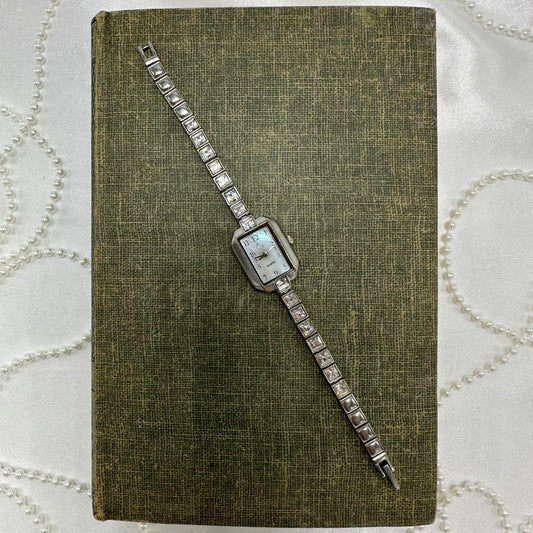 Silver tone GEORGE watch with rectangle mother of pearl dial and quartz movement.