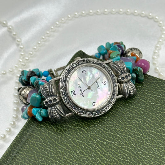 Silver tone Santa Fe watch with round mother of pearl dial and multicolor beaded band.