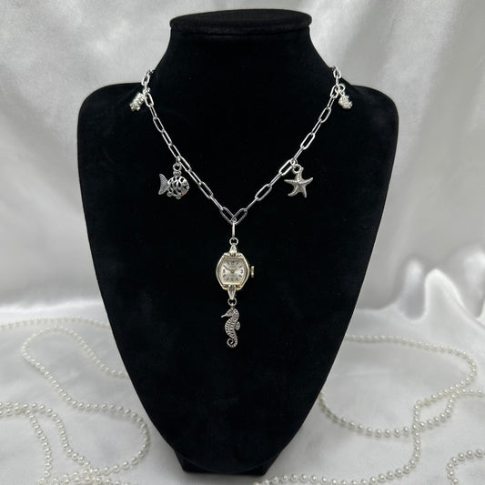 Silver tone paper clip chain charm necklace with vintage watch pendant. Watch does not run. Nickle free stainless steel chain.