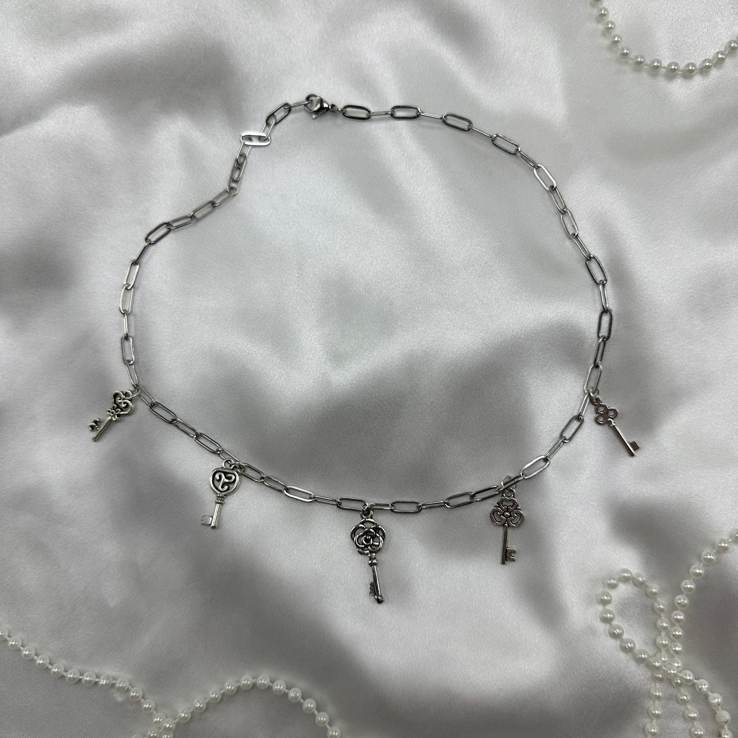 Silver tone paperclip chain necklace with vintage style skeleton key charms. Nickle free stainless steel chain.