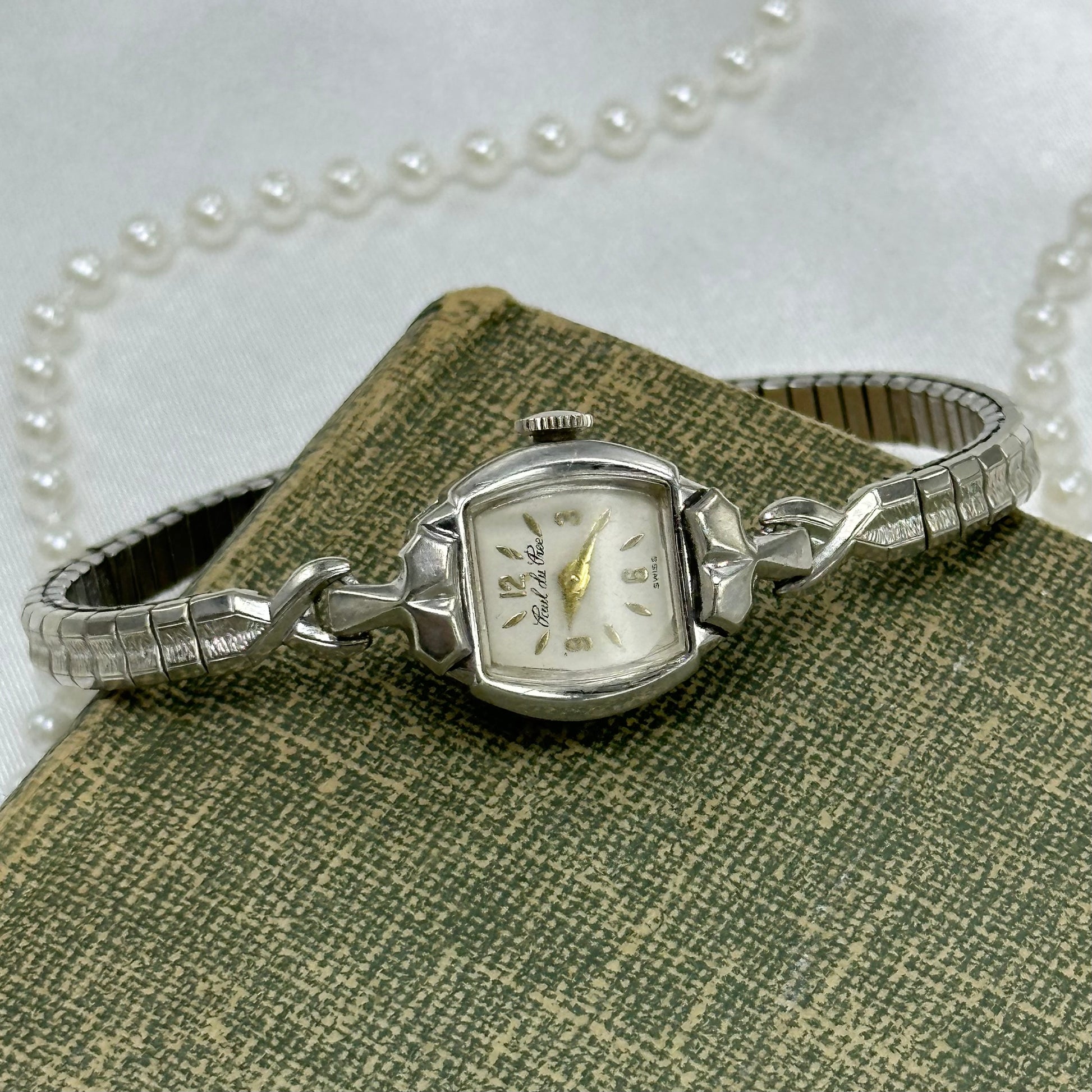 Vintage 10K RGP Paul du P manual winding Swiss made watch with detailed stretchable band and gold hands/markers.