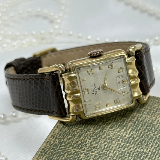 Vintage 10k gold filled manual winding Elgin De Luxe Watch with brown leather band and unique square dial.
