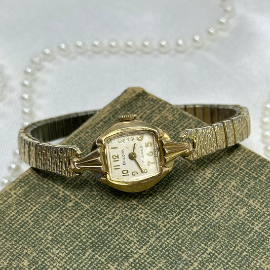 Vintage 10k rolled gold plated manual winding Bulova watch from the 1950's with detailed textured band. Watch comes with original BULOVA crown.