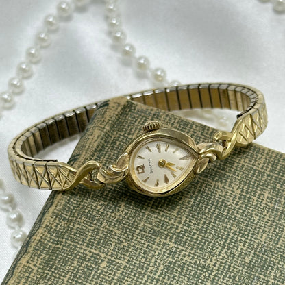 Vintage 10k rolled gold plated manual winding Bulova watch from the 1960's with stretchable detailed band and unique teardrop dial.