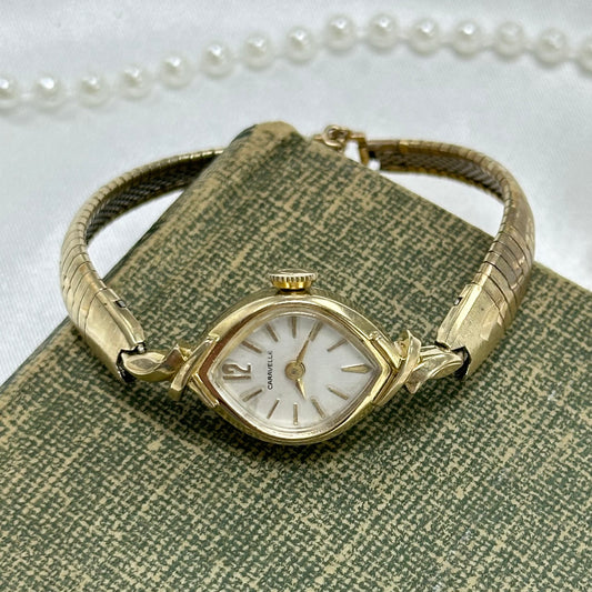 Vintage 10k rolled gold plated manual winding Caravelle by Bulova watch from the 1970's with detailed swirl pattern band and safety clasp. Watch comes with original C crown.