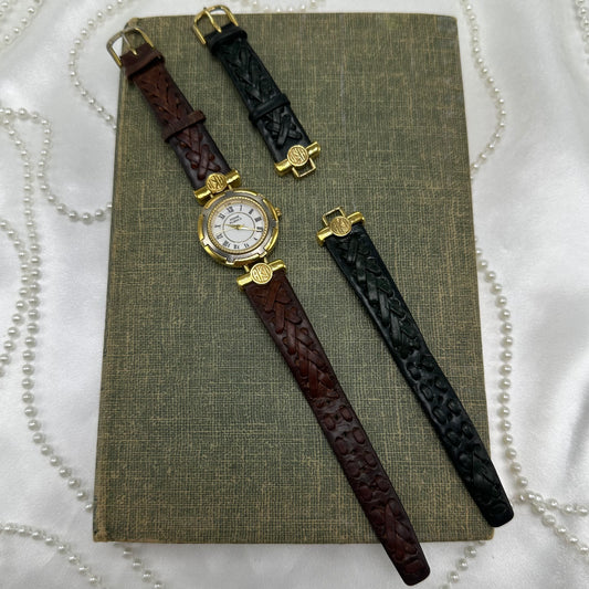 Vintage Anne Klein gold tone round dial watch with interchangeable black and brown leather braided bands. Dial screws off to swap bands easily.