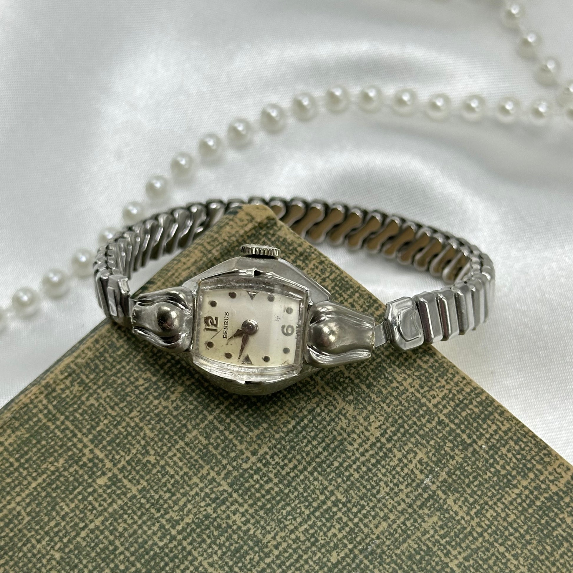 Vintage Benrus 10k rolled gold-plated manual winding watch with stretchable band from the 1950's. Watch comes with original BENRUS crown