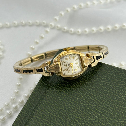 Vintage Bulova 10k rolled gold-plated manual winding cocktail watch with stretchable black and gold band from 1950's. Watch band is also 10k RGP.