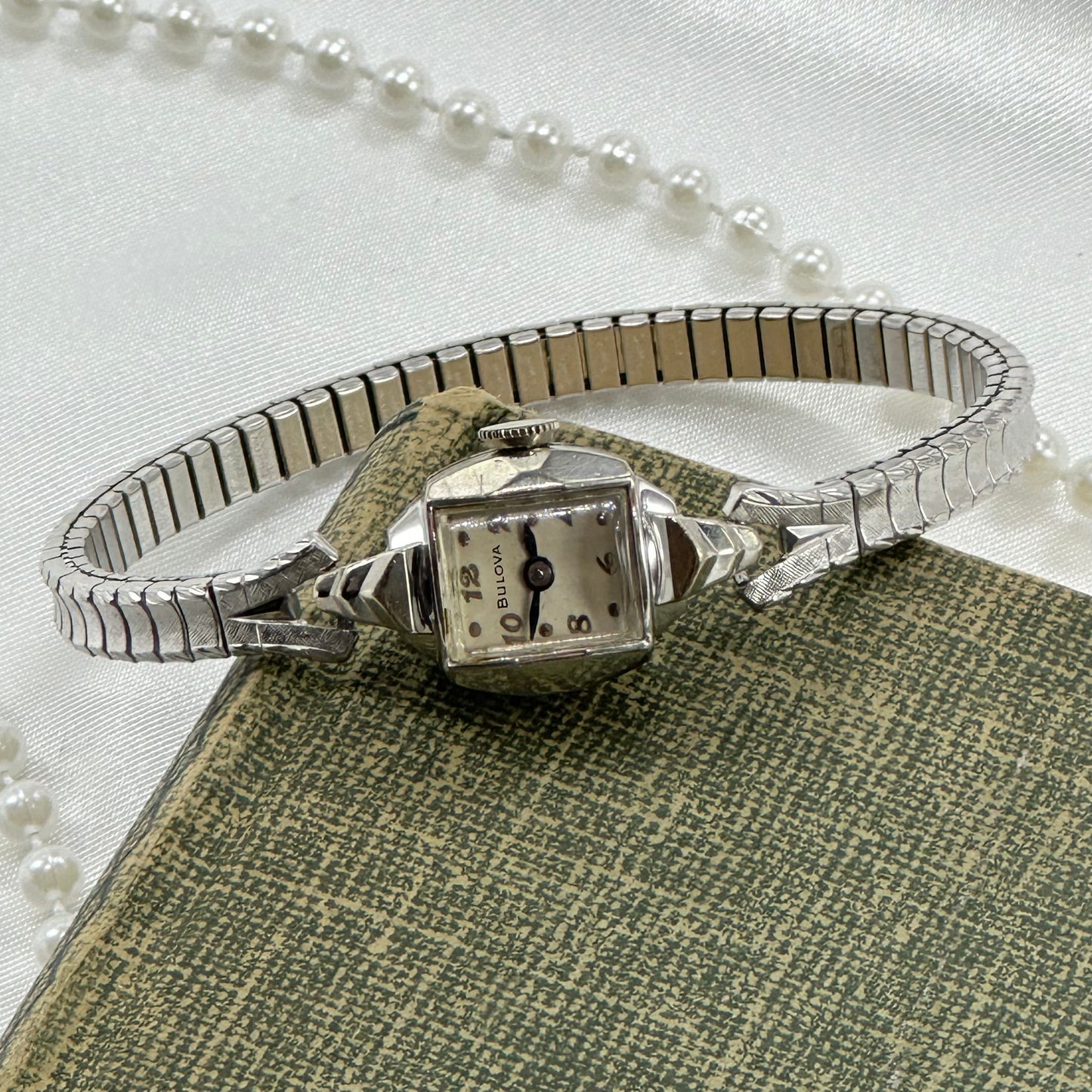 Vintage Bulova 10k rolled gold-plated manual winding watch with blue hands and stretchable band from the 1950's. 