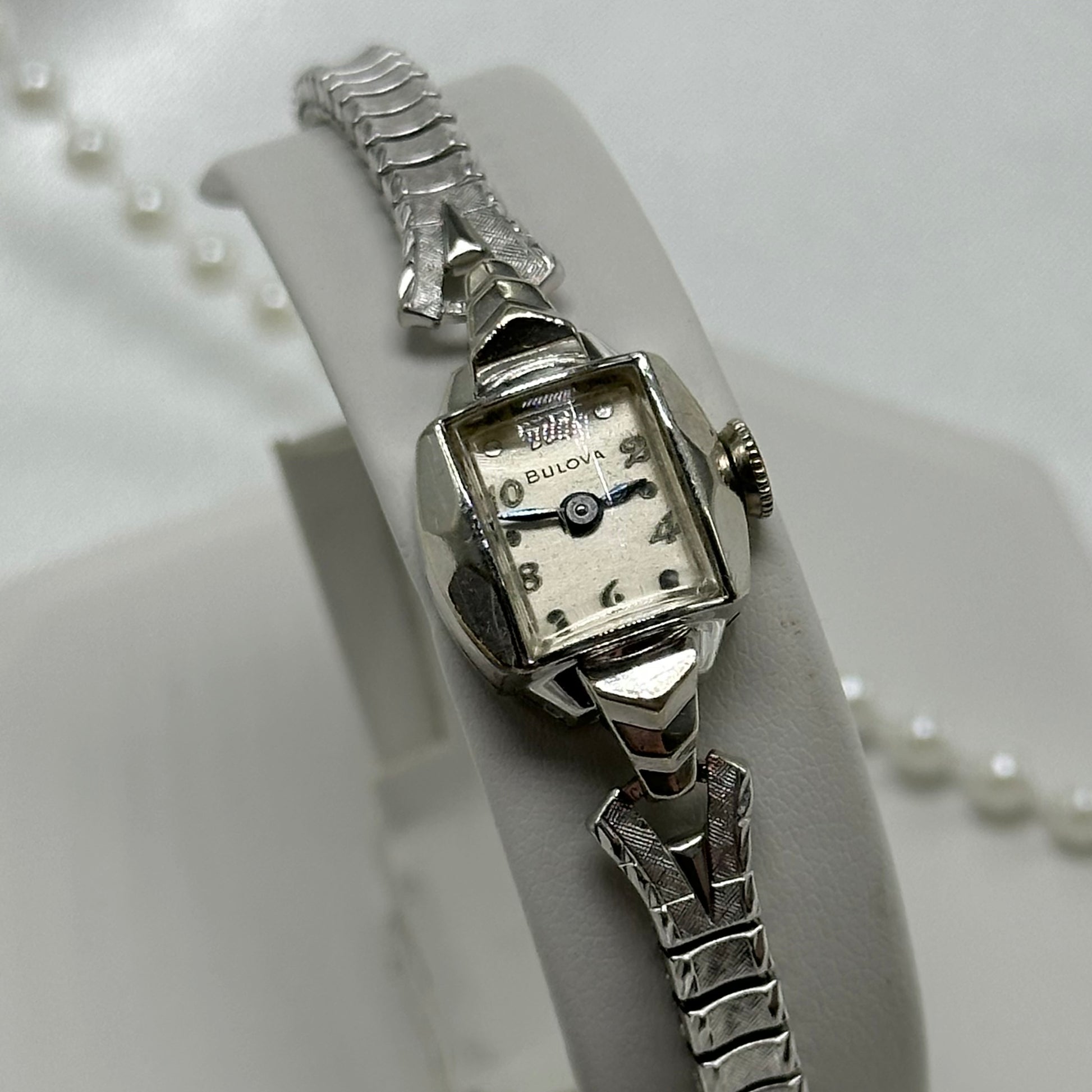 Vintage Bulova 10k rolled gold-plated manual winding watch with blue hands and stretchable band from the 1950's. Watch comes with original BULOVA crown