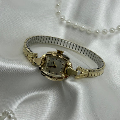 Vintage Bulova 10k rolled gold-plated manual winding watch with stretchable band. Watch comes with original BULOVA crown.