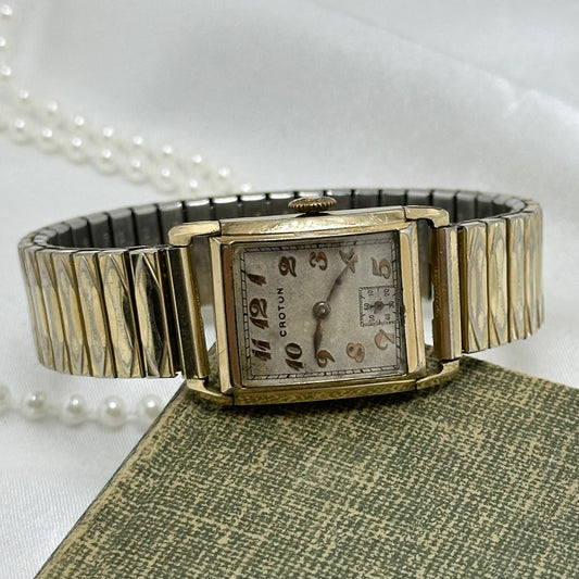 Vintage Croton 442905 manual winding Swiss made 7 jewels watch with sub second hand and rectangular dial. Gold tone Speidel band.