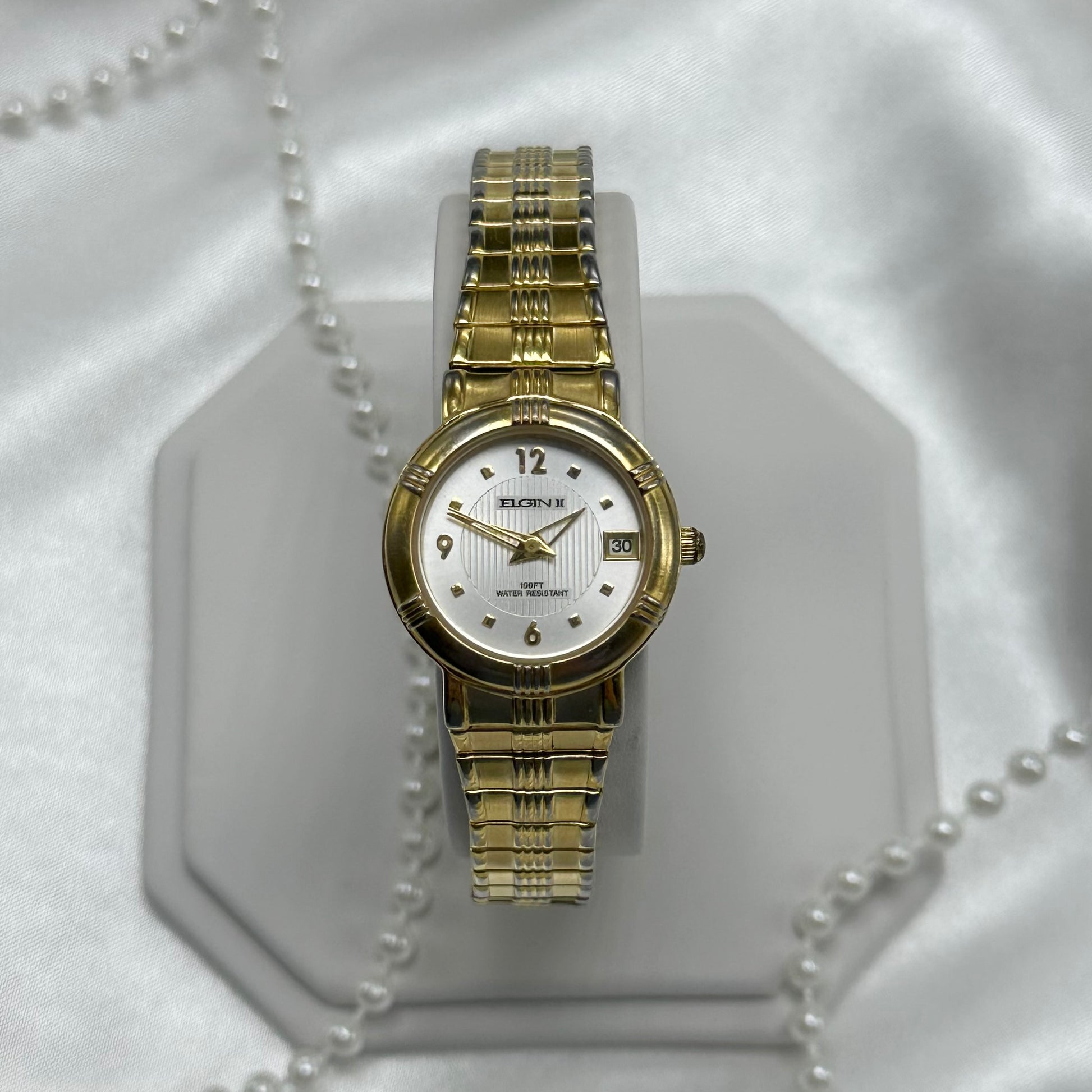 Vintage Elgin II water resistant watch with date display and stretchable band