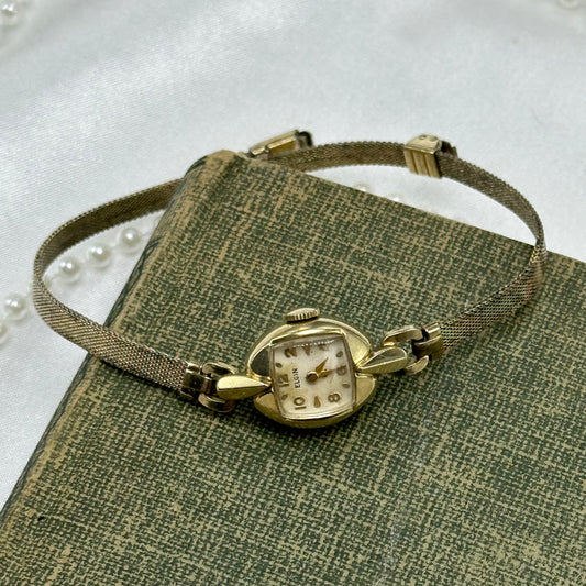 Vintage Elgin manual winding cocktail watch with sliding clasp band from the 1950's. Watch bezel is 10k RGP. Watch band is 12k RGP.