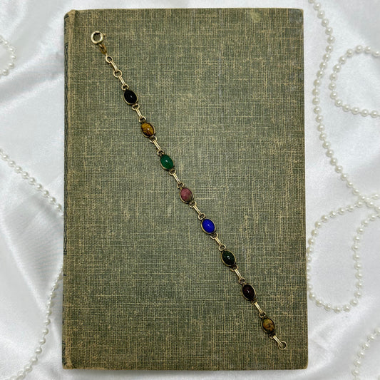 Dainty vintage gold tone bracelet with multicolor scarabs.